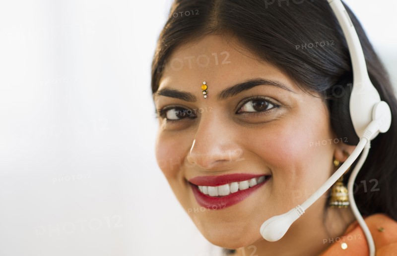 Indian woman in traditional Indian clothing talking on headset