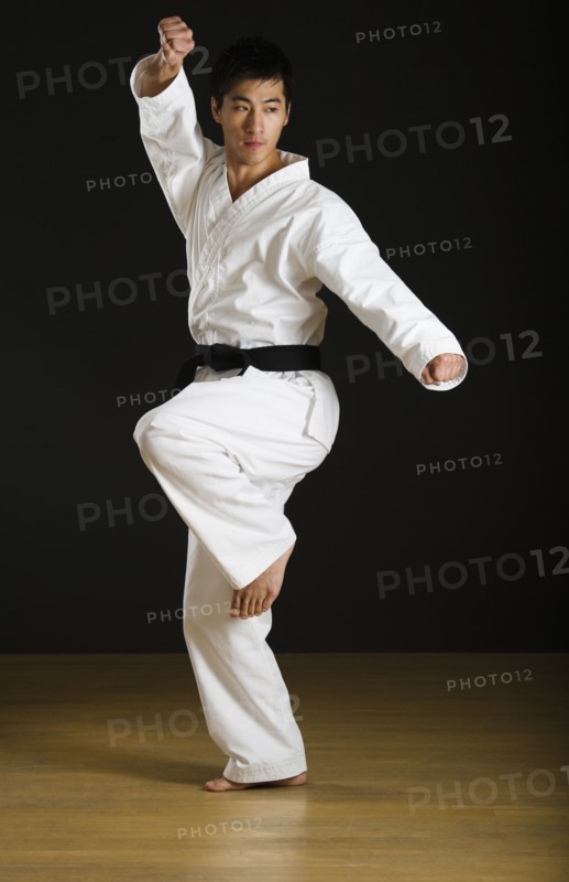 Asian male black belt practicing karate