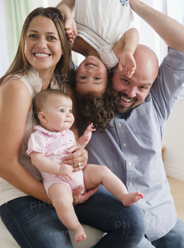 Mother and father playing with daughters