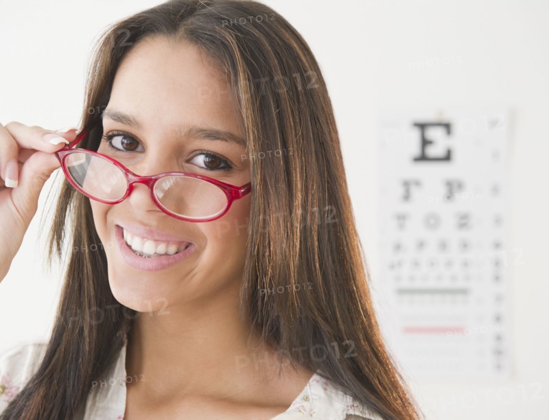 Hispanic teenage girl having eye exam