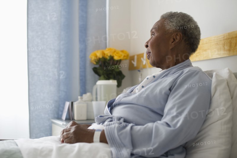 Black woman recovering in hospital bed