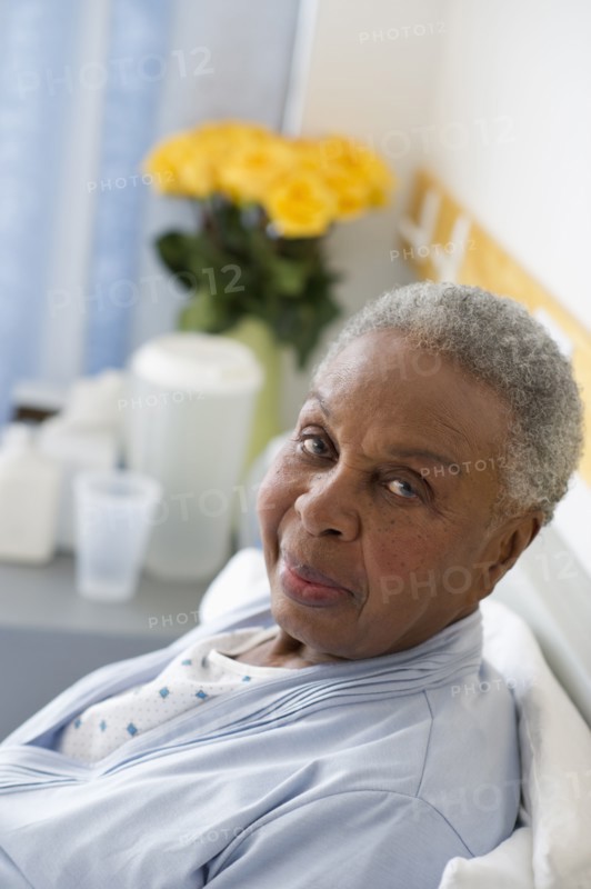 Black woman recovering in hospital bed