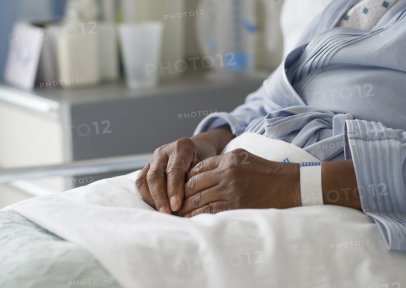 Black woman recovering in hospital bed