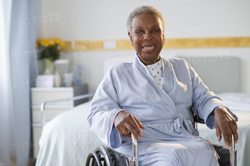 Black woman sitting in wheelchair in  hospital