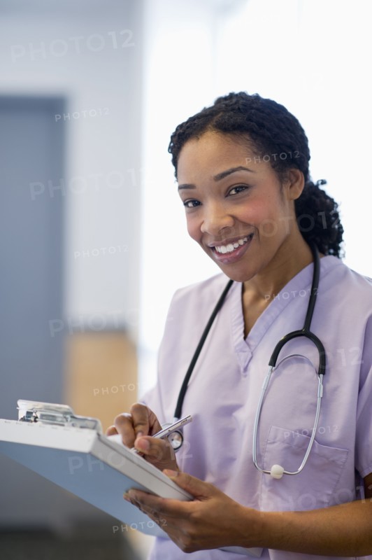 Nurse writing in medical record in hospital