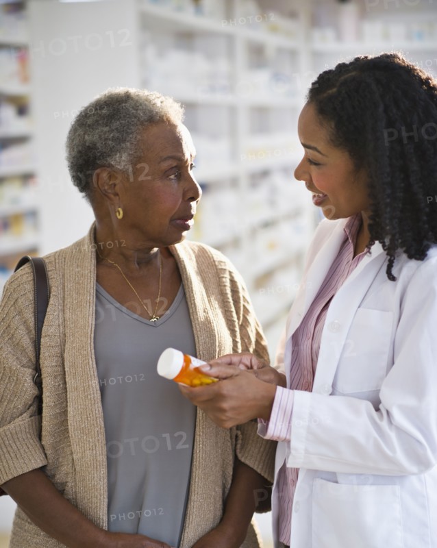 Pharmacist explaining medication to woman