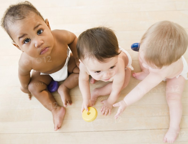Babies playing together on floor