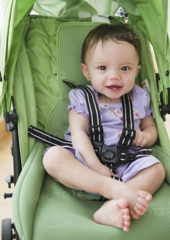 Mixed race baby sitting in stroller