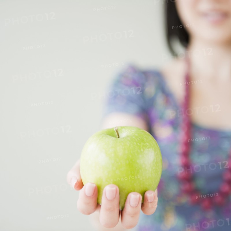 Korean woman holding green apple