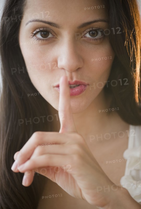 Brazilian woman making shhh gesture