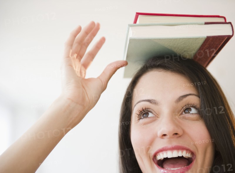 Brazilian woman balancing books on her head