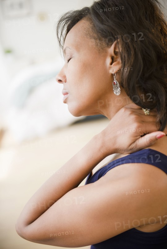 Black woman rubbing her neck