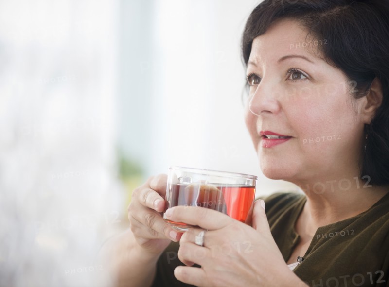 Hispanic woman drinking tea