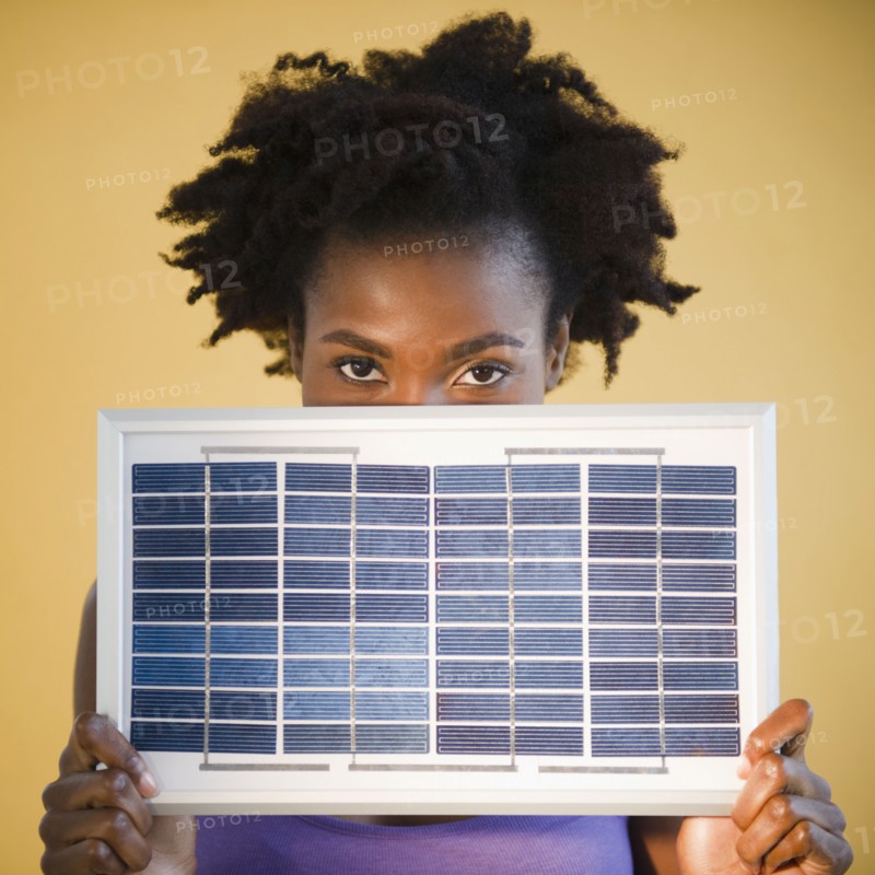Black woman holding solar panel