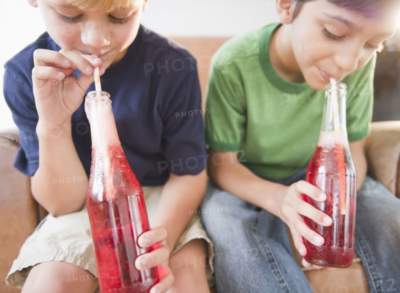 Boys drinking soda together