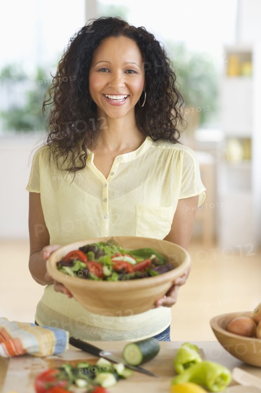 Hispanic woman preparing salad