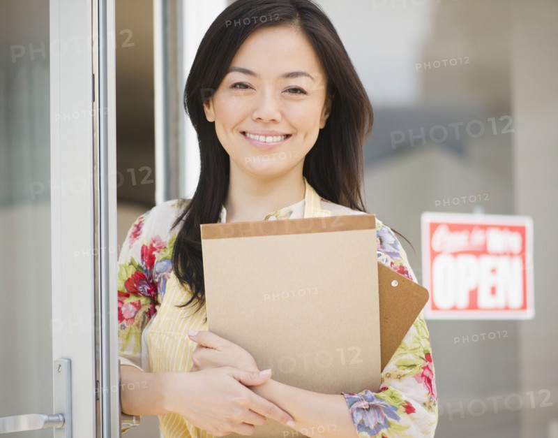 Smiling Japanese woman holding notepad