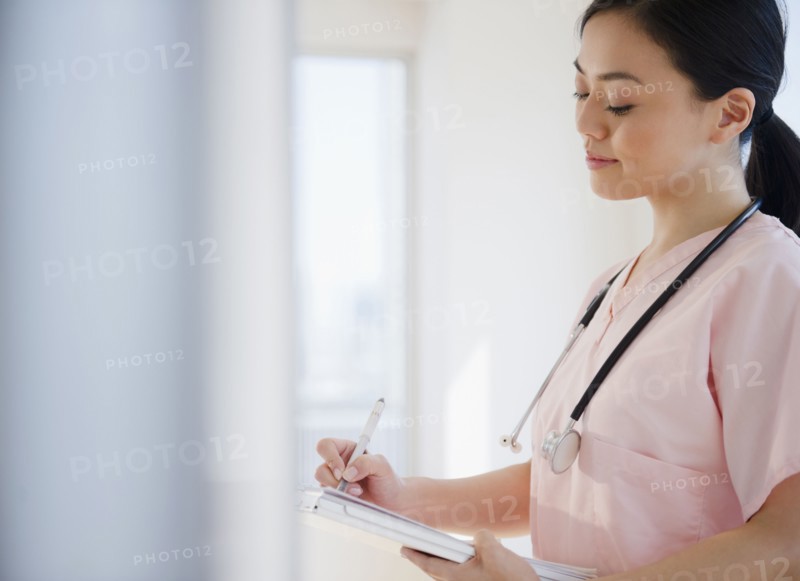 Japanese nurse writing on medical record