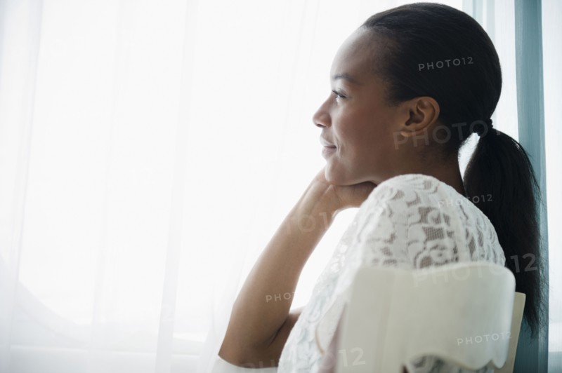 Smiling Black woman thinking