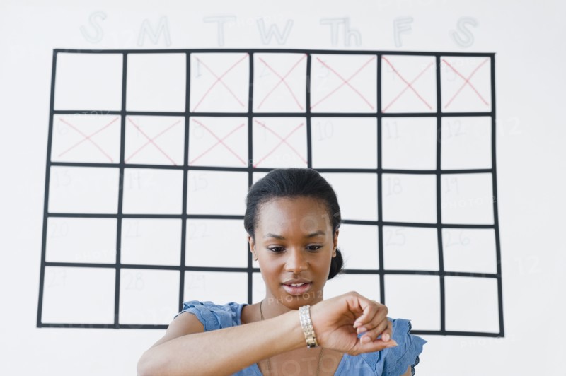 Black woman checking her wristwatch