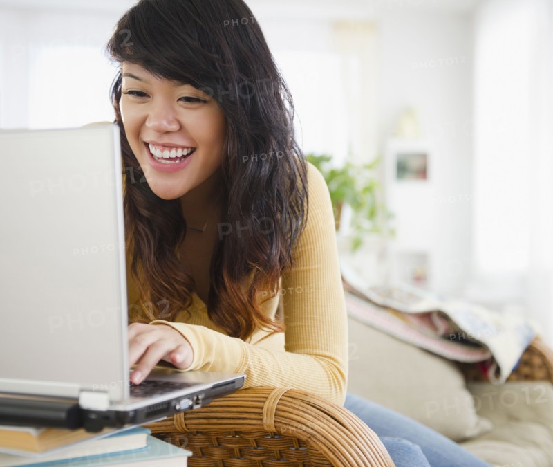 Pacific Islander woman typing on laptop