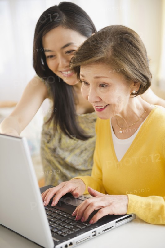 Japanese mother and daughter using laptop together