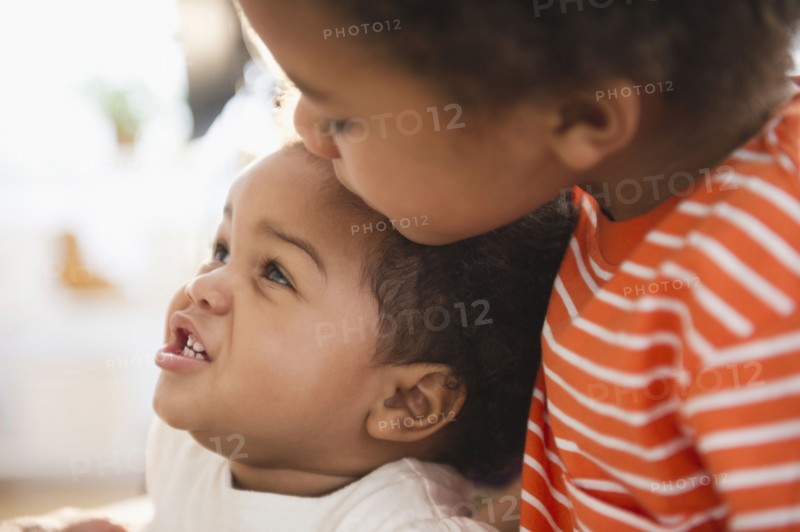 Black boy hugging sister