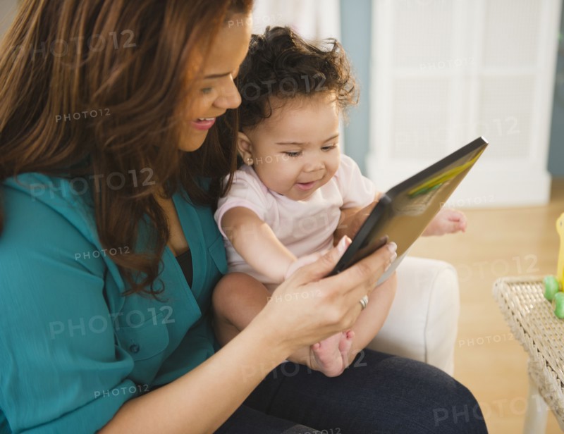 Mixed race mother and baby using digital tablet