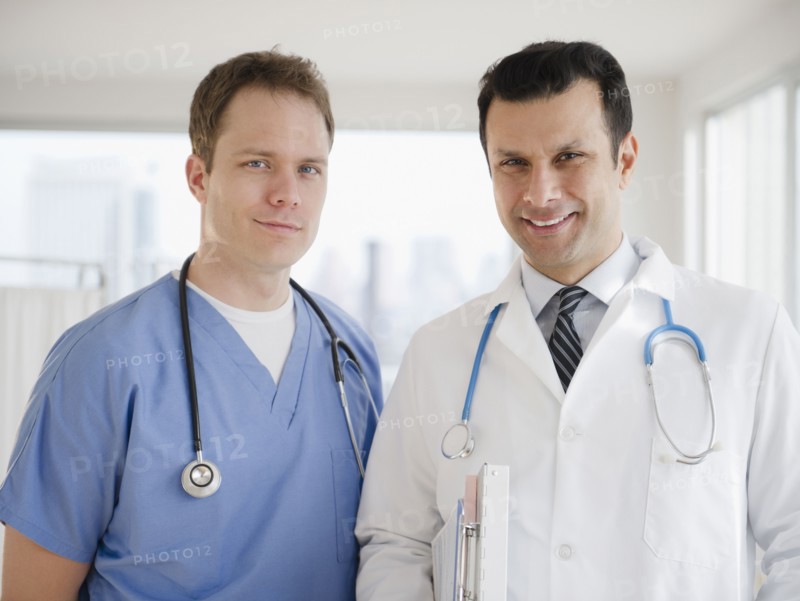 Smiling doctor and surgeon in hospital