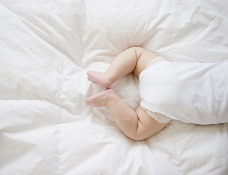 Mixed race baby boy laying on floor