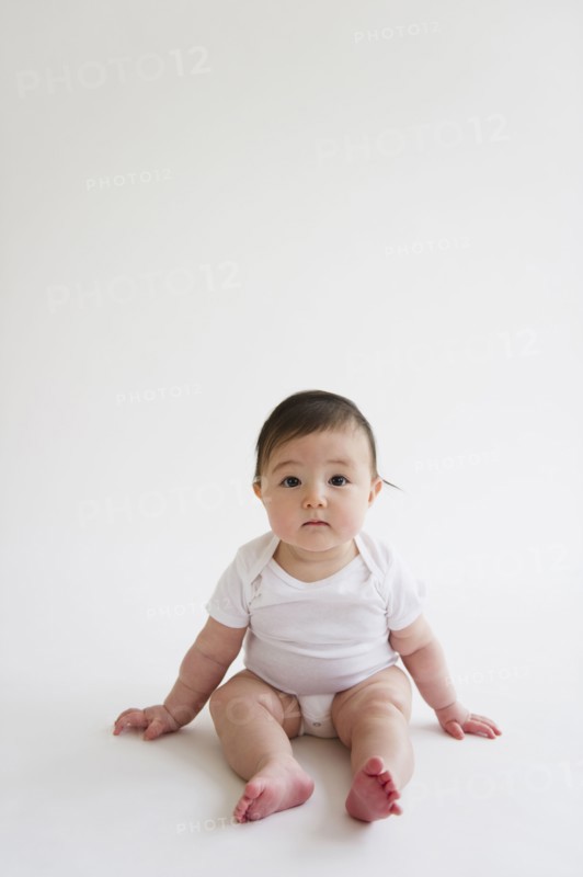 Asian baby girl sitting on floor
