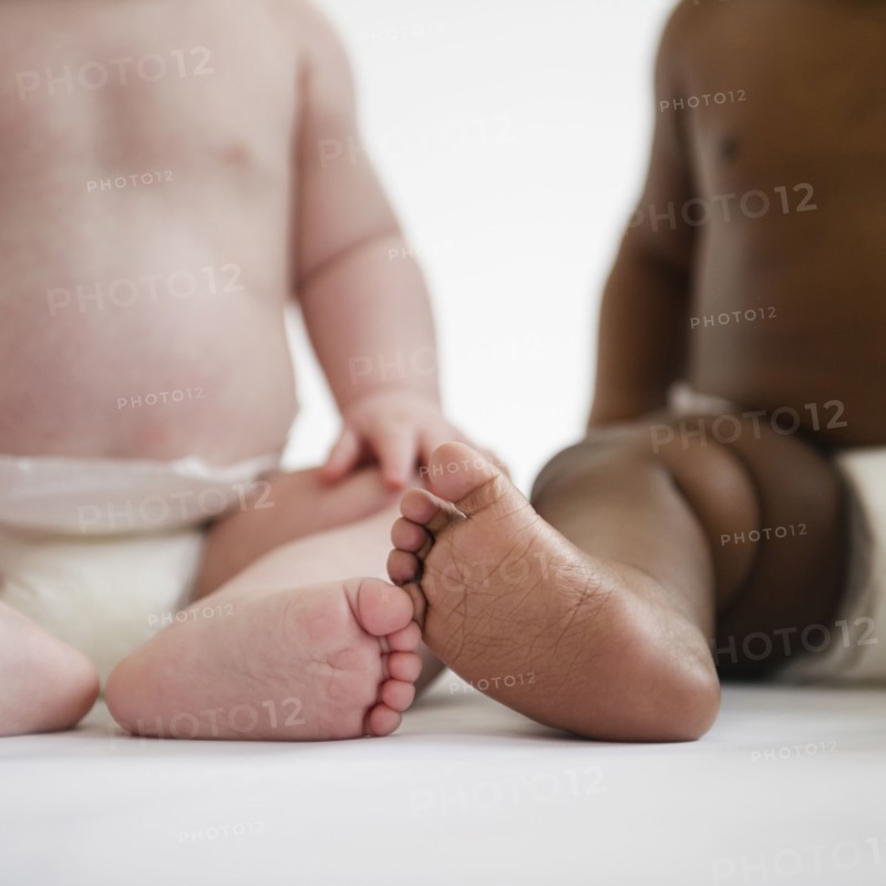 Babies sitting on floor together
