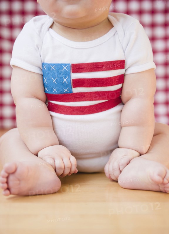 Caucasian baby boy in onesie with American flag on it