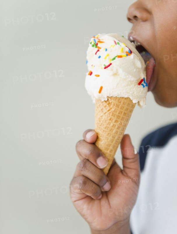 Black boy licking ice cream cone