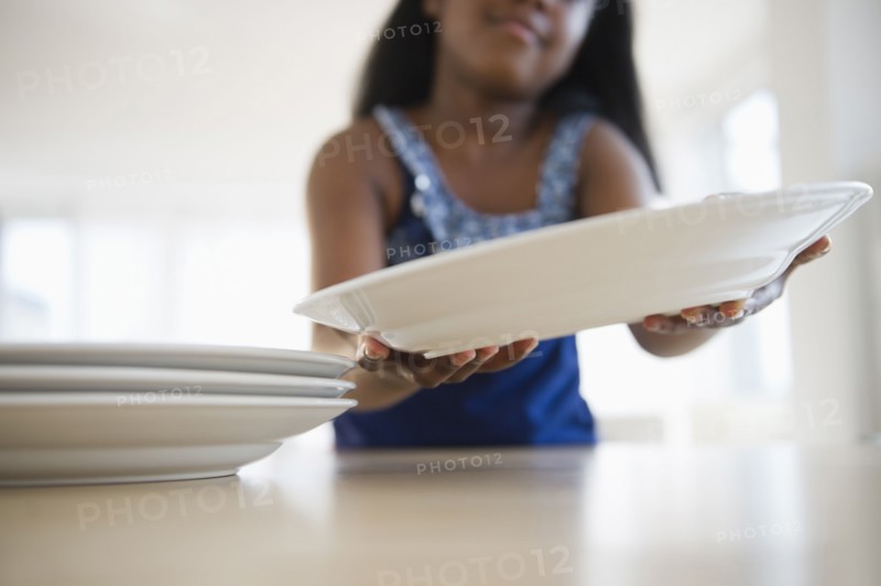 Black girl setting the table