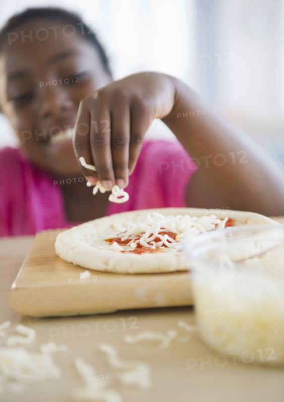 Black girl making pizza
