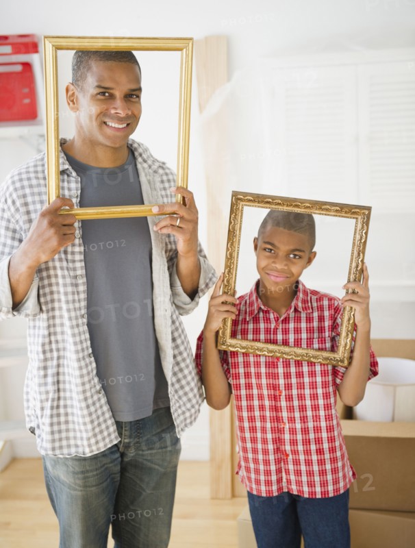 Father and son looking through empty frames