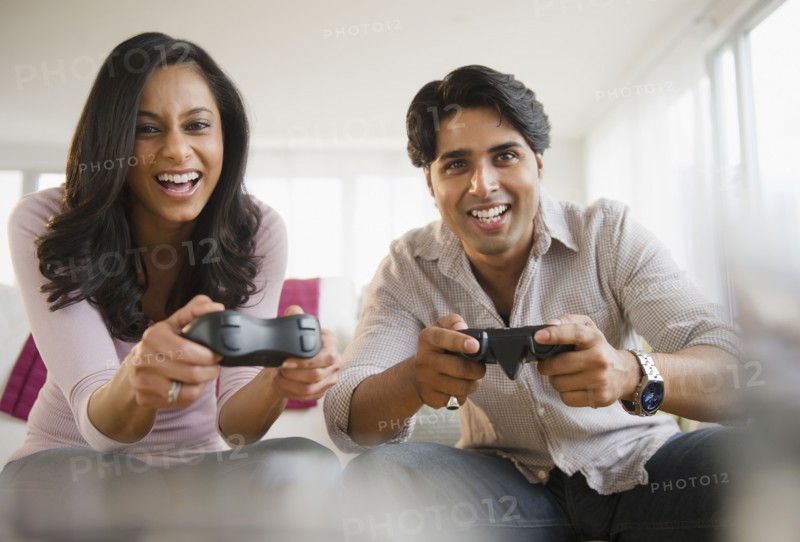 Mixed race couple playing video game