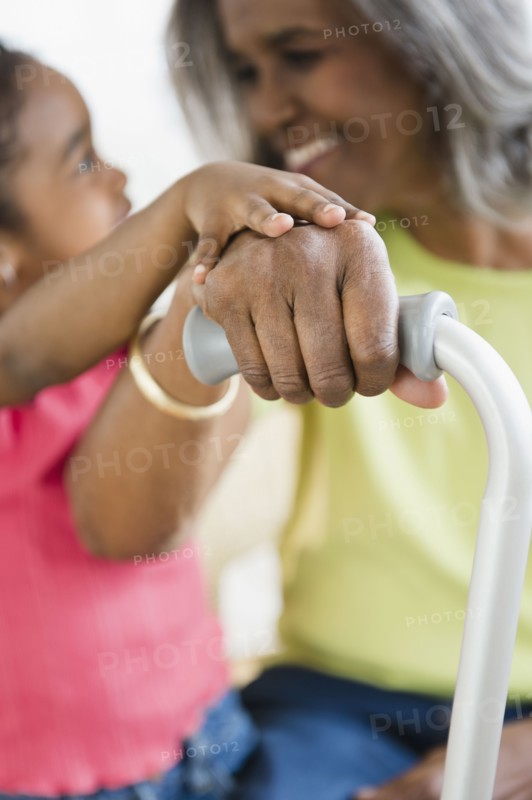 African American girl holding hands with grandmother