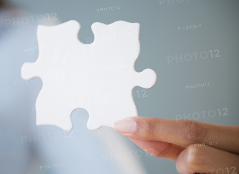 Cape Verdean woman holding puzzle piece