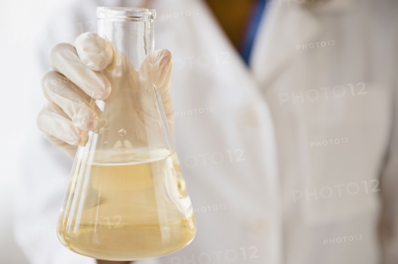 Cape Verdean scientist holding chemical in beaker