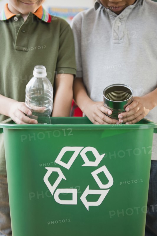 Boys recycling together