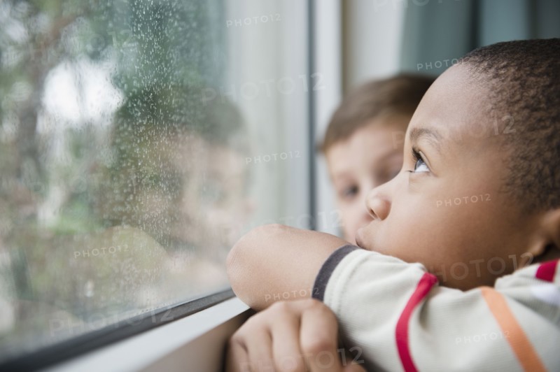 Boys looking out window together