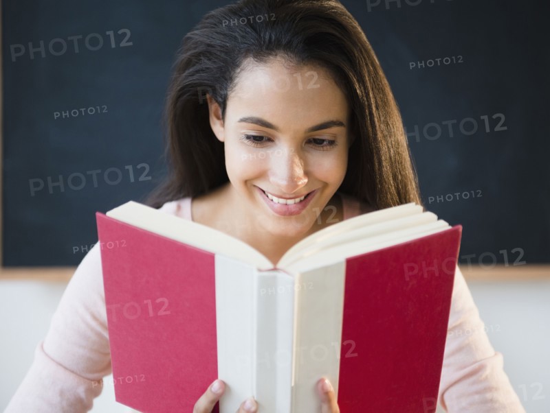 Hispanic teenager reading book