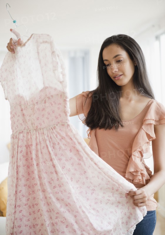 Hispanic teenager looking at dress