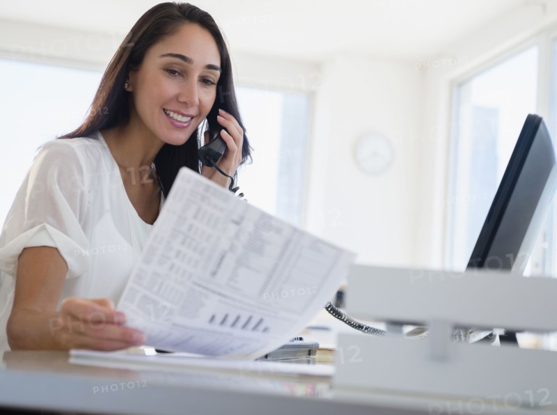 Caucasian businesswoman working at desk