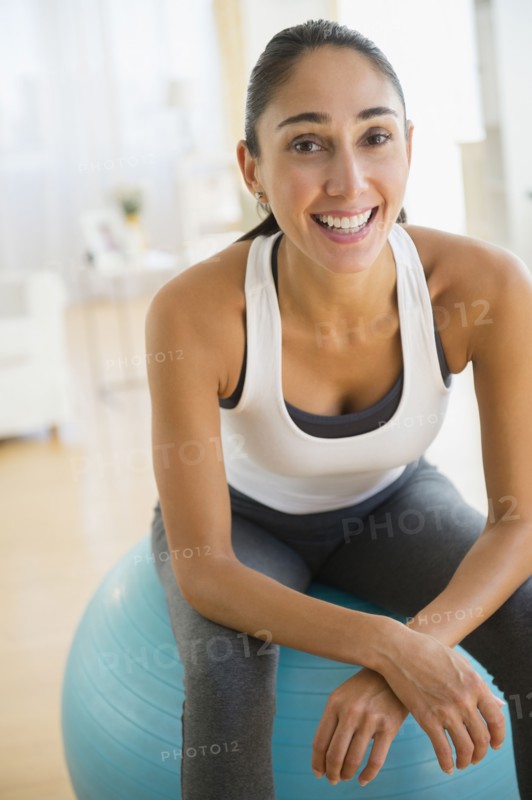 Caucasian woman sitting on exercise ball