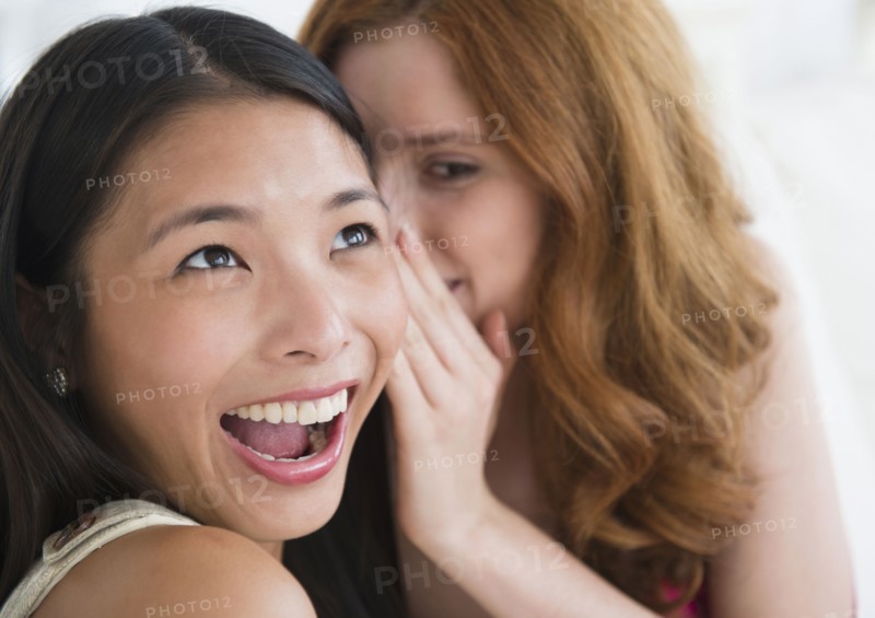 Women whispering to each other