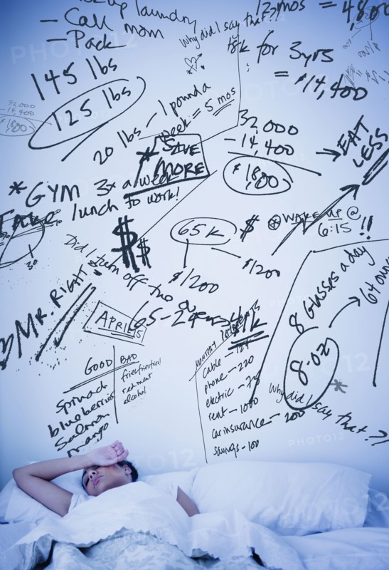 Hispanic woman with scribbled worries over bed