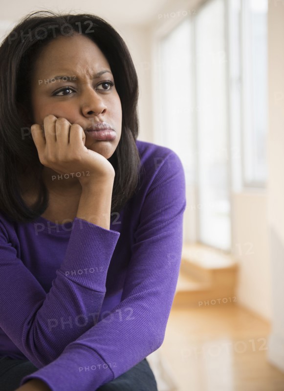 Anxious African American woman frowning